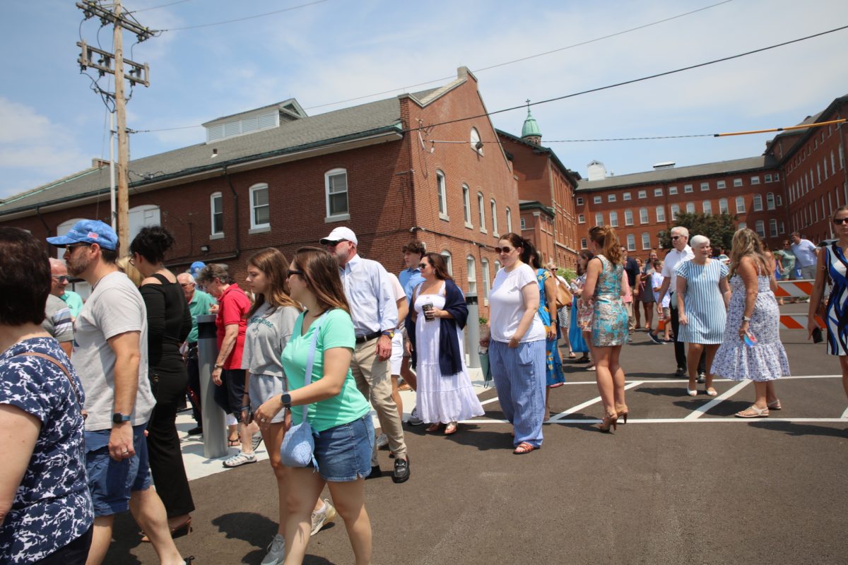 Following the ribbon-cutting ceremony on Aug. 9, a large crowd heads towards Notre Dame High School's new building for a tour.