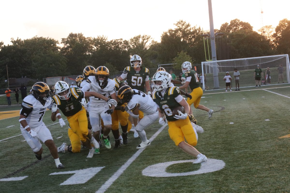 Running back Kevin Fisher, a Lindbergh senior, carries the ball down the field on Aug. 27 while his teammates attempt to hold back members of the opposing team.