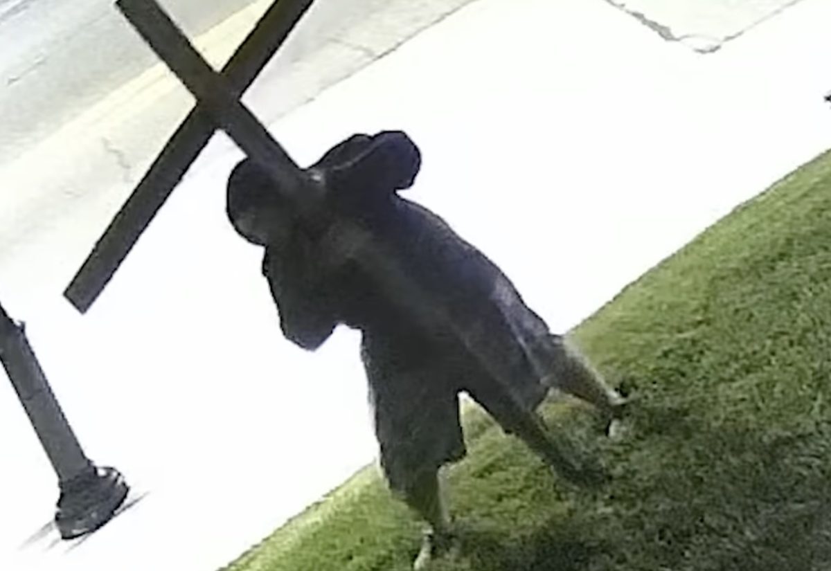 An unknown individual damaging a wooden cross on the front lawn of Gethsemane Lutheran Church, 700 block of Lemay Ferry Road, on Aug. 5, 2026. Photo courtesy of the St. Louis County Police Department.