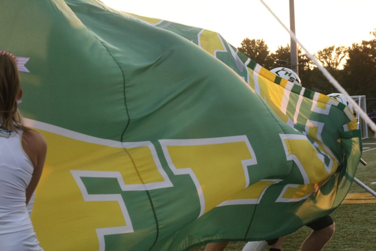 The Lindbergh High School football team runs through a banner before entering the field on Sept. 11. 