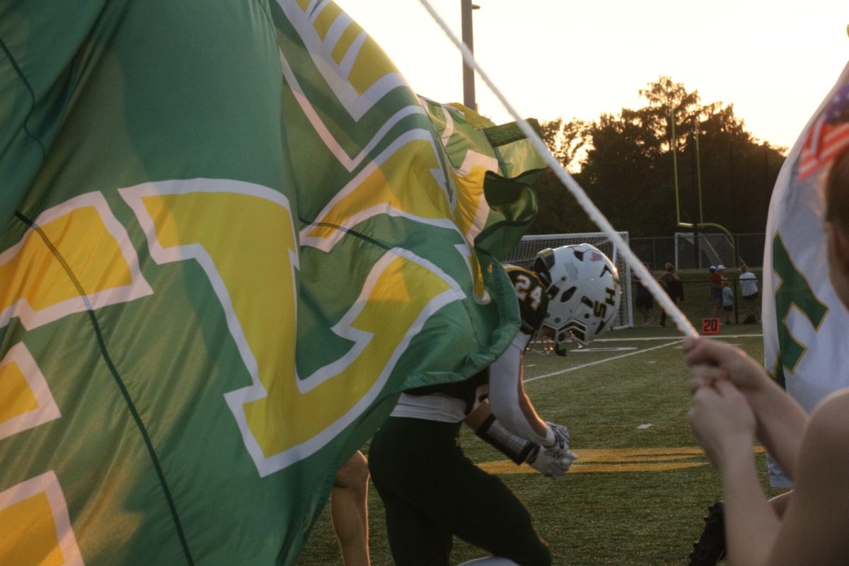 The Lindbergh High School football team runs through a banner before entering the field on Sept. 11. 