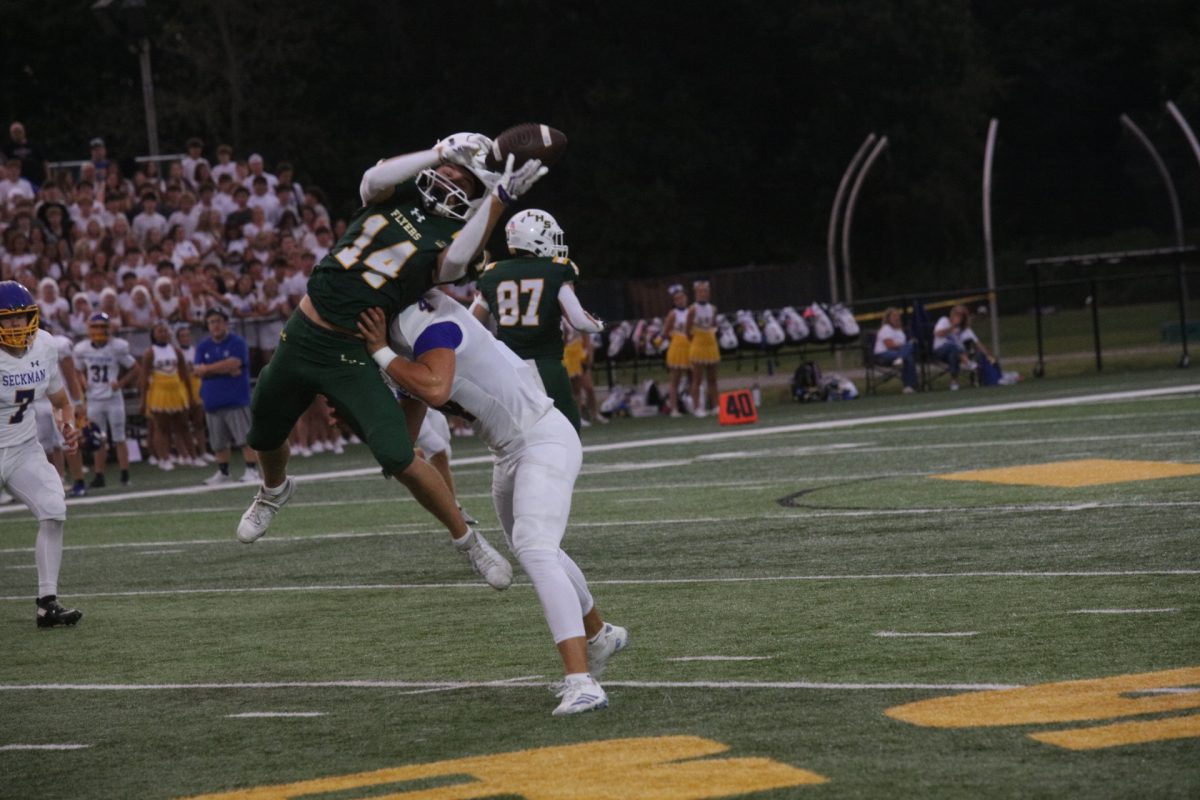 Following the first responders and military appreciation celebrations, the Flyers took the field against Seckman. Pictured above, Lindbergh's Joey Luczak (#14) jumps to catch a ball while a Seckman player attemps to tackle.