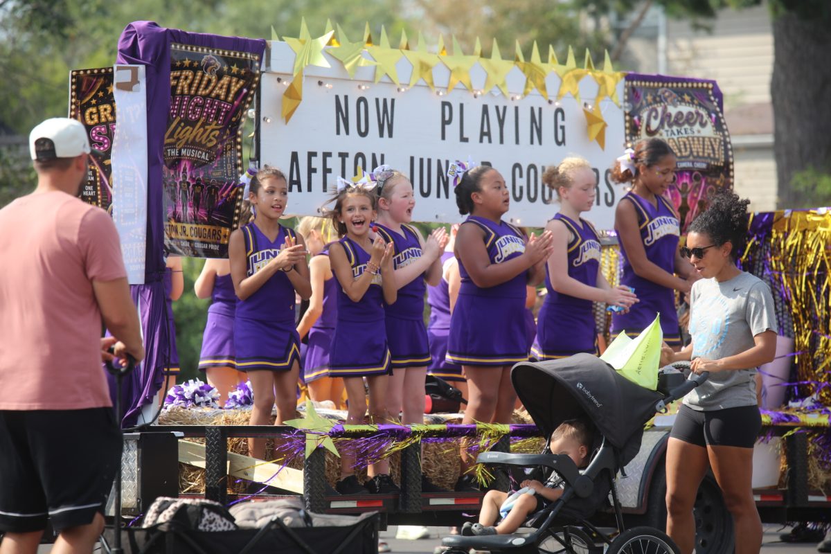 The Affton Junior Cougars perform a short cheer routine on their float in the Affton-Lemay Community Parade, which took place on Sept. 19.