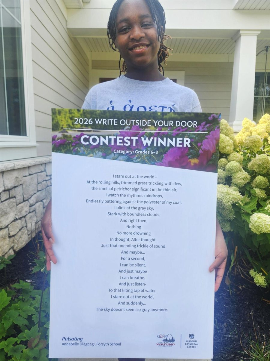 Annabelle Olagbegi holds a copy of her poem, "Pulsating."
