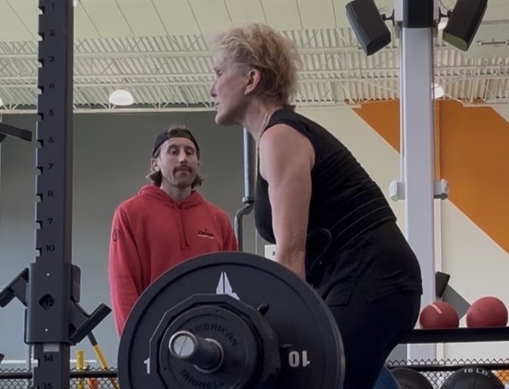 Sally Haas (right) lifts weights with her personal trainer, Zach Cayer. Photo courtesy of Sally Haas.