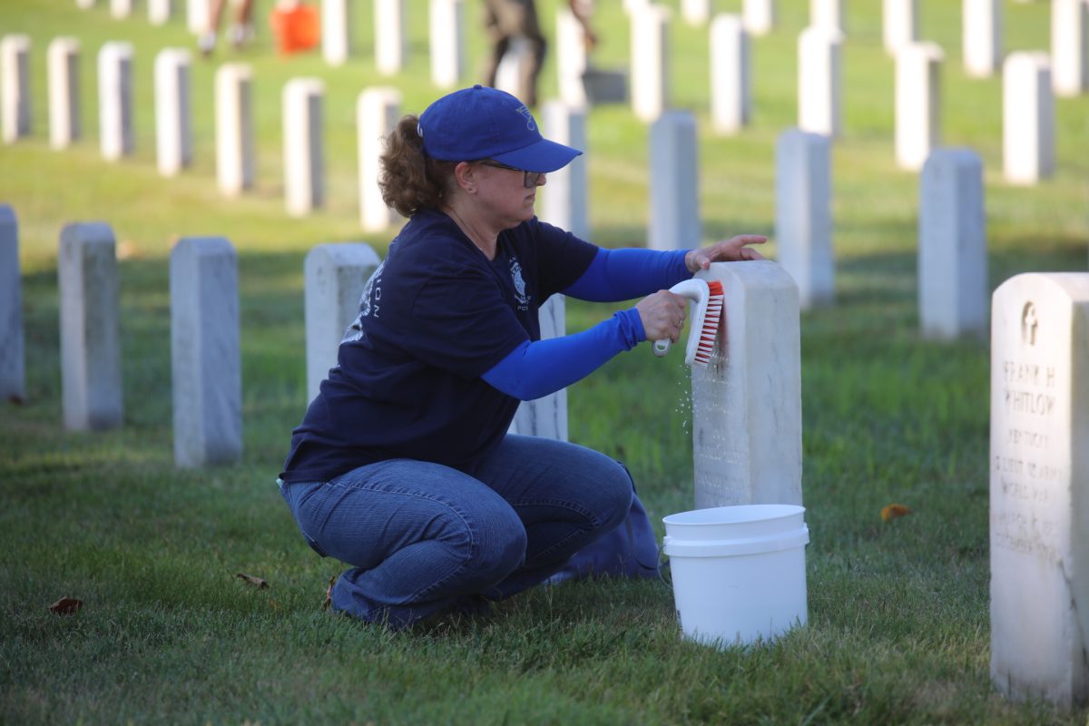 A volunteer at the Carry the Load event scrubs a headstone. The event took place at Jefferson Barracks National Cemetery, 2900 Sheridan Road, on Sept. 12.