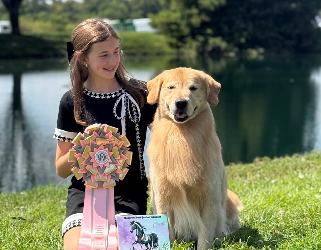 Freshman Sadie Butterfield poses with Banks the golden retriever. Photo courtesy of Lutheran High School South.