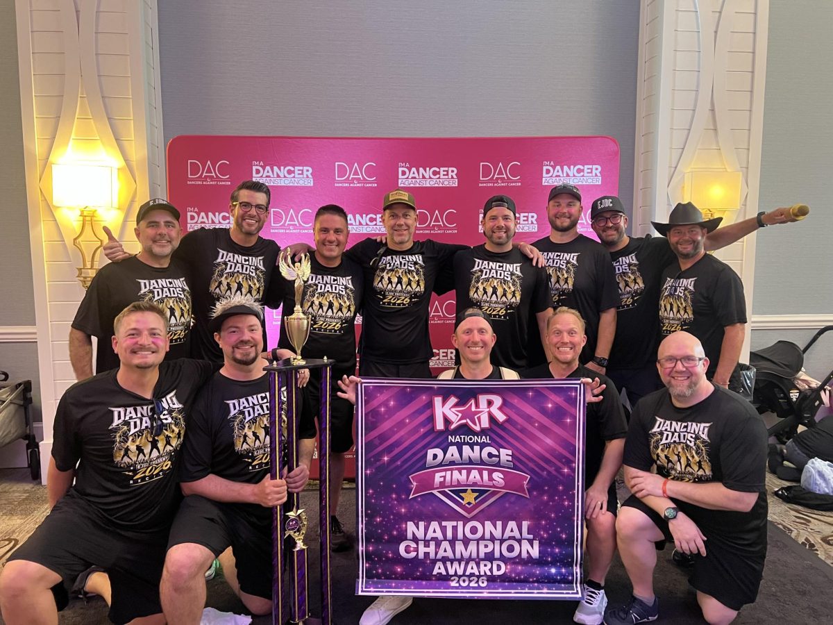 The fathers from Emily Jane Dance Center pose with their trophy after the Mehlville studio raised the most money for Dancers Against Cancer from the national competition. Photo courtesy of Emily Streigel.