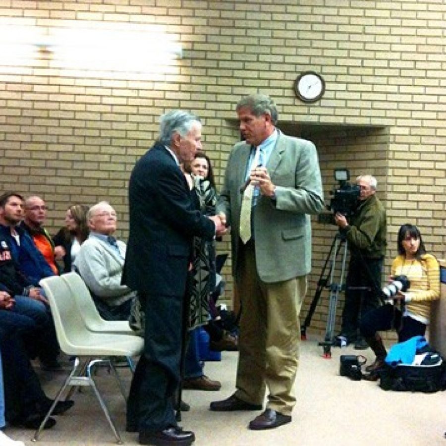 Mayor Mark Furrer presents an award at Tuesday nights Board of Aldermen meeting, as the bicyclist he allegedly hit with his car, Randy Murdick, looks on, in orange third from left.