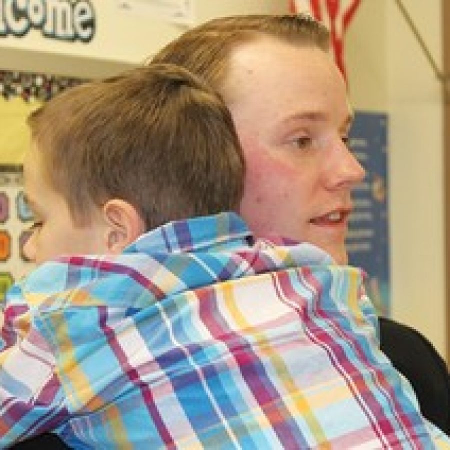 Navy Ensign Jeremy Oliver hugs his son David after surprising the second-grader last week at Rogers Elementary School. 