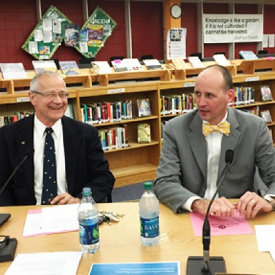 Incoming Mehlville Superintendent Chris Gaines, right, attends his first Mehlville Board of Education meeting with Superintendent Norm Ridder, left.