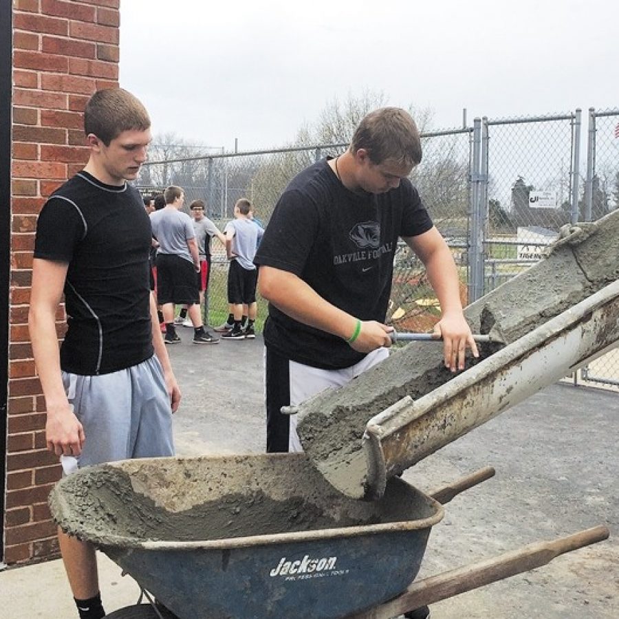 Oakville High School students, parents, coaches, residents and local business owners have been volunteering this spring to renovate the schools locker rooms, which have never been updated since the school opened in 1974. Among those volunteering, from left, are Oakville students Desi Kirchhofer and Ryan Peterson.