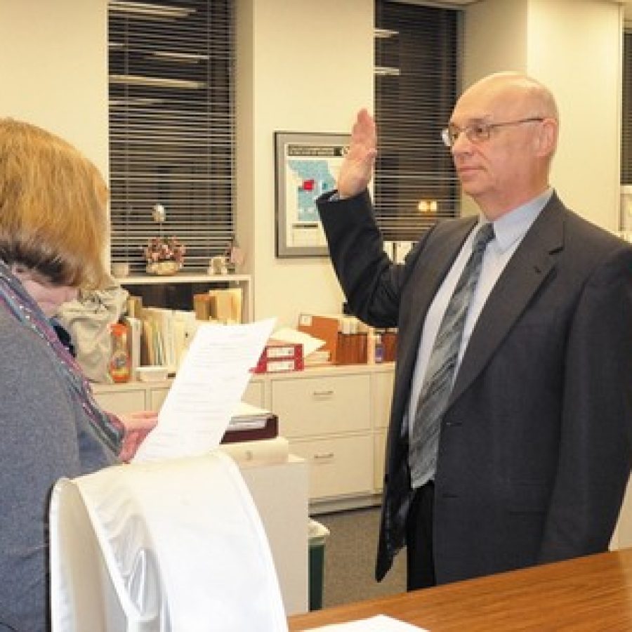 Deputy County Clerk Jeanette Hook administers the oath of office to Director of Revenue Greg Quinn last week. Quinn, a Republican who represented District 7 on the County Council for 23 years, was appointed to the post by County Executive Steve Stenger, D-Affton.