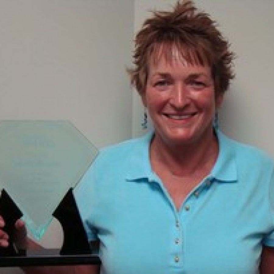 Jan Hoffmann with her 2010 award from the city for going door to door to convince elected officials to build the first Sunset Hills municipal pool. 