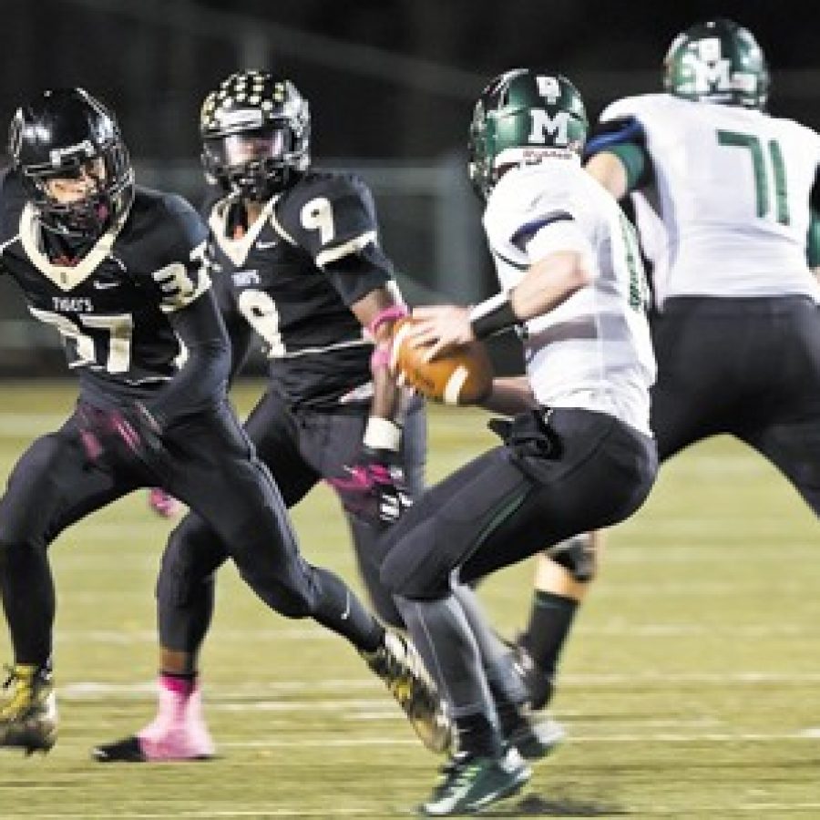 Oakville Highs Christian Niehoff, No. 37, and Demetrius Harris, No. 9, pursue Mehlvilles Brendan Mady, No. 10, in Friday nights game in which the Panthers edged the Tigers 17-14. Also pictured is Mehlvilles Shane McGroaty, No. 71. Megan LeFaivre-Zimmerman photo