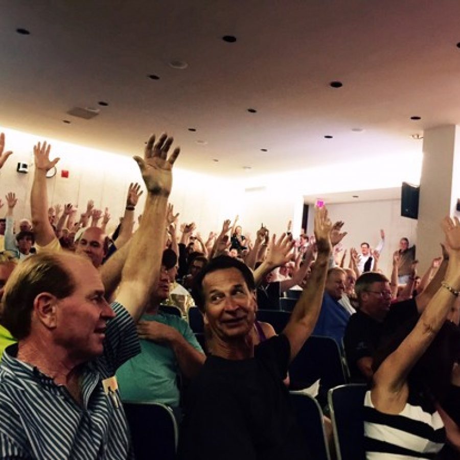 Residents opposed to the apartments proposed for Tesson Ferry and Bauer roads raise their hands against the project at the June 20 Planning Commission public hearing.