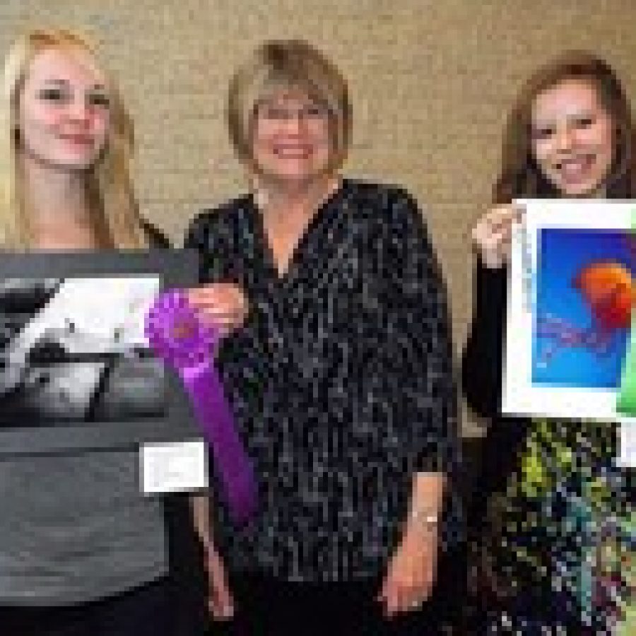 Oakville High School seniors Katelynn Armstrong, left, and Megan McQuitty, right, are pictured with OHS photography instructor Joan Larson after the awards ceremony at the recent Olivette Photo Show. 