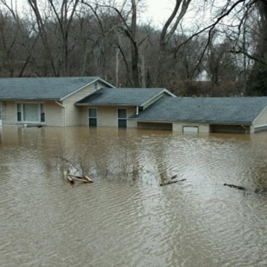 Above, the home of the Hayes family at the intersection of Weber Hill and West Watson roads in Sunset Hills the day after floodwaters forced the family out of their house.