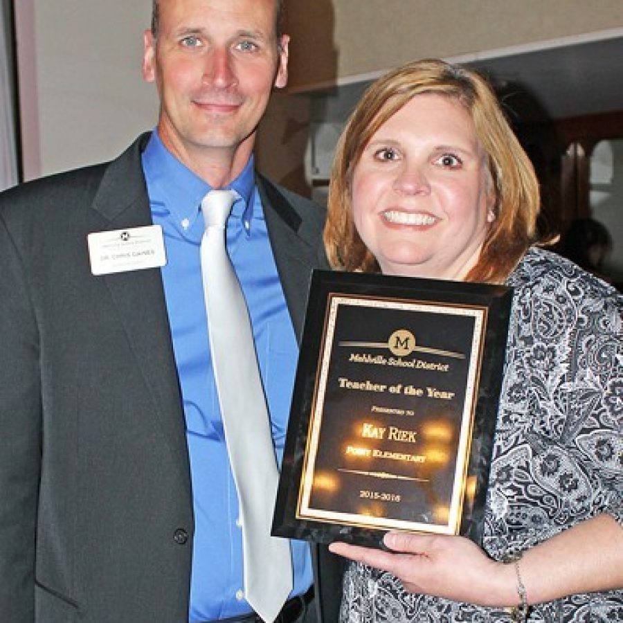 Kay Riek, a fourth-grade teacher at Point Elementary School, is the Mehlville School Districts Teacher of the Year. She is pictured with Superintendent Chris Gaines at the districts annual Recognition Night.