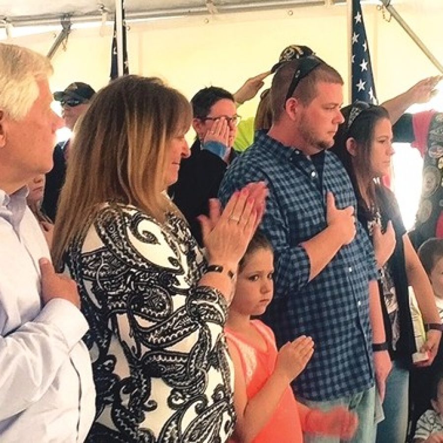 Members of Lemay native Amanda Pinsons family recite the Pledge of Allegiance while looking at a picture of her during last weeks dedication ceremony for the Sgt. Amanda N. Pinson Post Office in Affton. Pictured, middle, are: Pinsons mother, Chris Andrews, and from left, Chris husband, Rick, Pinsons brother Bryan Pinson, his wife, Sarah, and their children.