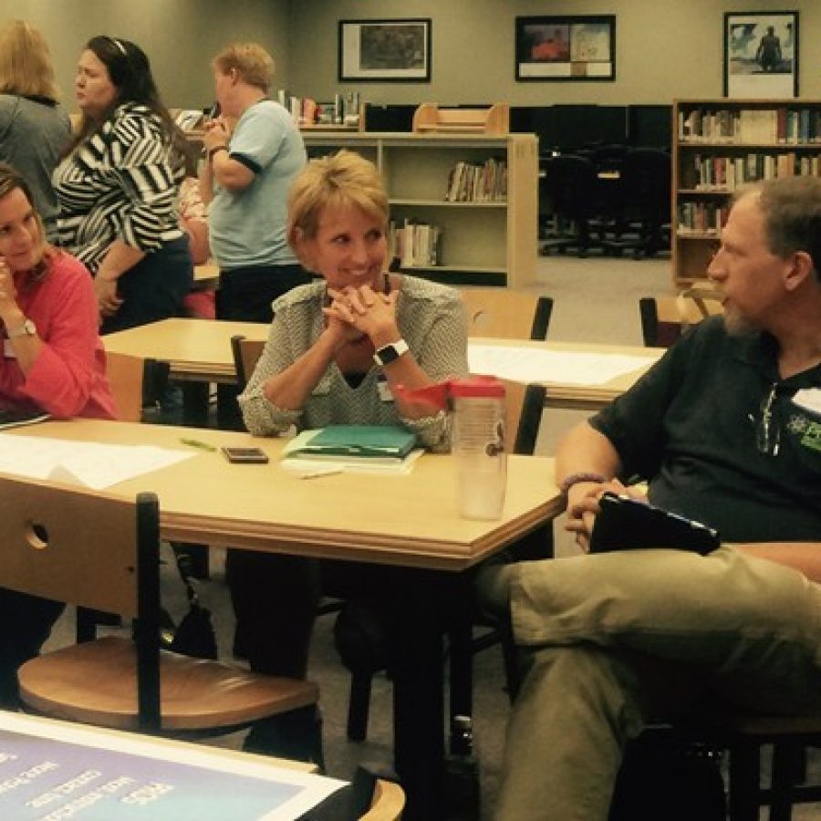 Scheduling Review Committee member and Oakville High School teacher Jim Kreyling, right, talks to fellow committee member Peggy Hassler, center, during last weeks public meeting on block scheduling at OHS.