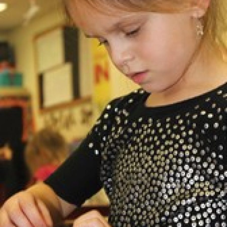 Cambelle Gartland, a kindergarten student at Hagemann Elementary School, assembles a rainbow-loom, rubber-band bracelet for patients at SSM Cardinal Glennon Childrens Medical Center. Hagemann third-graders and their kindergarten buddies recently got together to make the bracelets. 