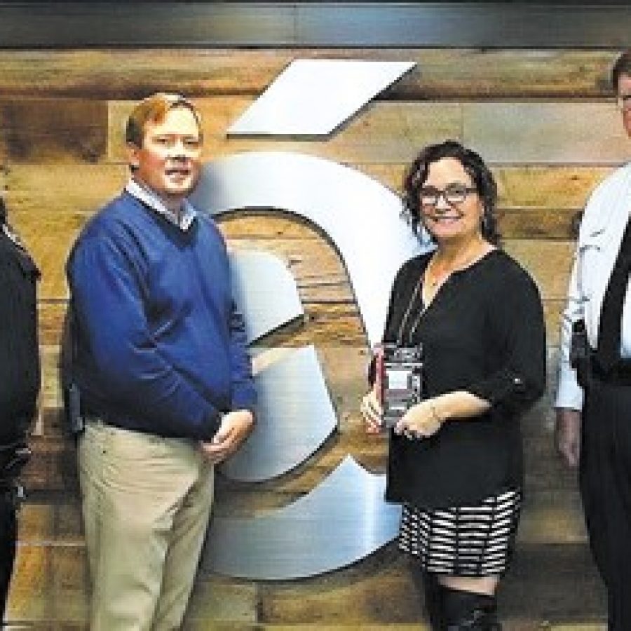 Jason and Erica Hughes of the Accent Group present an individual trauma kit to Crestwood Police Chief Frank Arnoldy, right, and Officer Dion Olson.