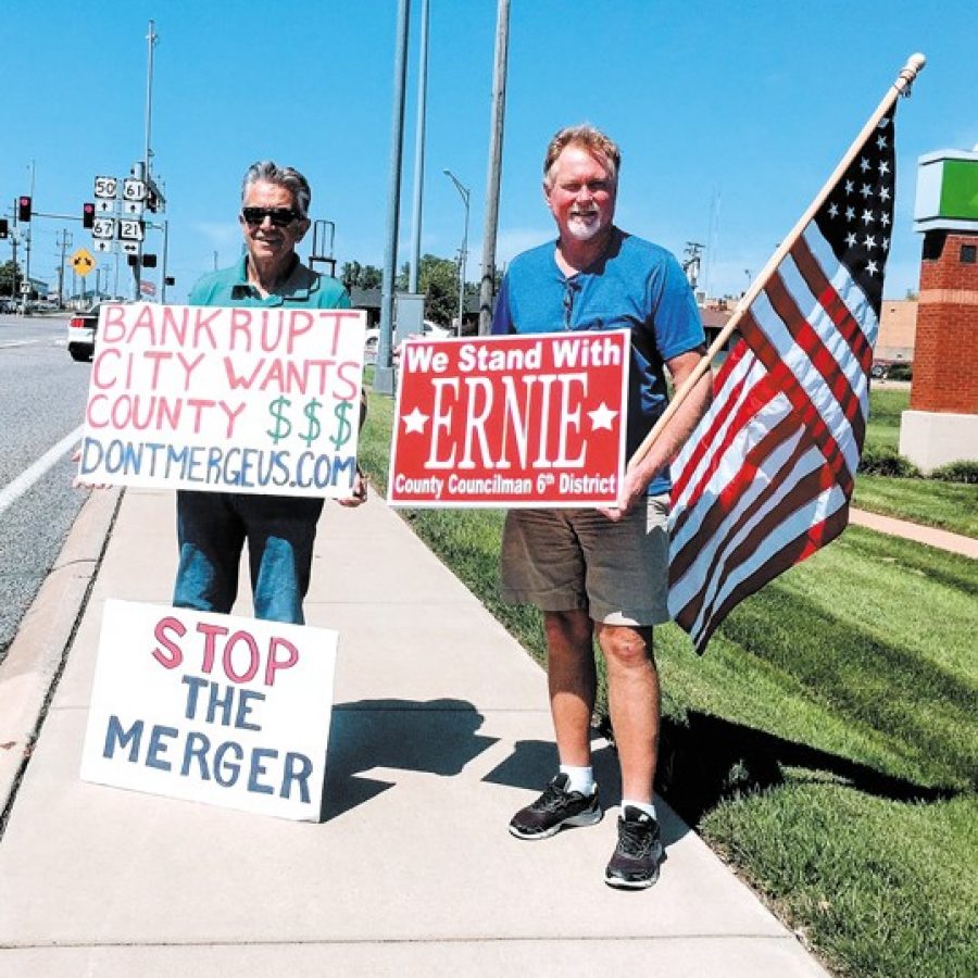 Roughly 20 members of south county Republican groups waved signs in a show of support Saturday for 6th District Councilman Ernie Trakas, R-Oakville, at the intersection of South Lindbergh Boulevard and Tesson Ferry Road. Trakas himself made an appearance at the event with signs against a city-county merger. The councilman is pictured alongside supporter Paul Alvino of Oakville, right.