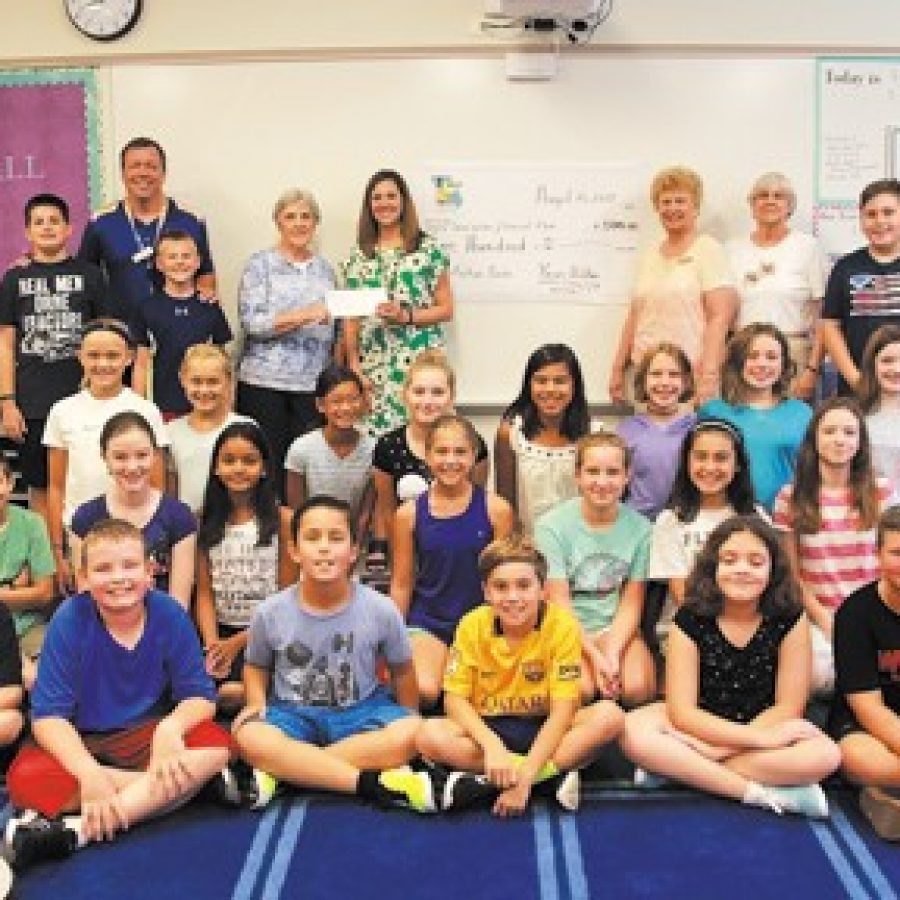 The Missouri Retired Teachers Foundation recently presented Dressel Elementary School fifth grade teacher Sarah Valter, center, green dress, with a \$500 grant to purchase 50 nonfiction books for her classroom library.