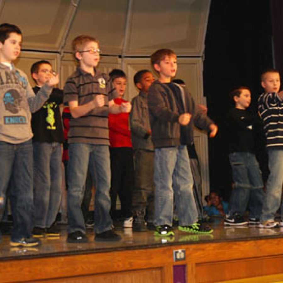 Hagemann Elementary School fifth-graders, from left, Tommy Thuston, Col-by Potter, Cameron Siebum and Matthew Caraway perform for Mehlville School District 60plus Club members when their school hosted the 'Hagemann Honors Heroes' 60plus event last week. More than 140 members of 60plus Club participated in a patriotic celebration at Hagemann Elementary in honor of Pearl Harbor Remembrance Day.