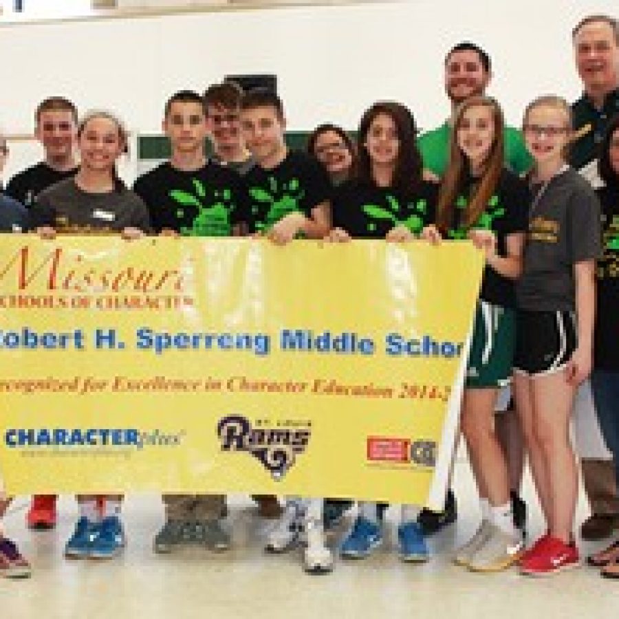 Sperreng Middle School Principal Mark Eggers, back row, far right, is shown with with students and staff following the presentation of Sperrengs Missouri School of Character banner. 