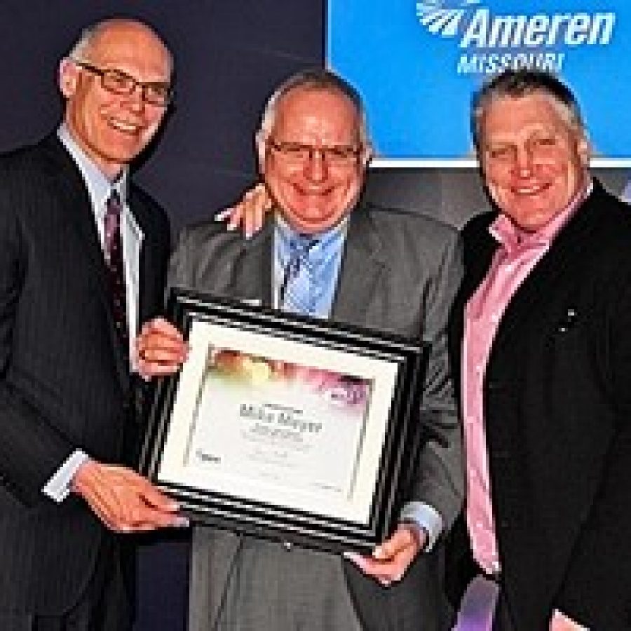 Warner L. Baxter, left, chairman, president and chief executive officer of Ameren Missouri, presents the 'Community Lights' award to Angels' Arms volunteer Mike Meyer, center, with NHL Hall of Famer and former Blues hockey star Brett Hull. 