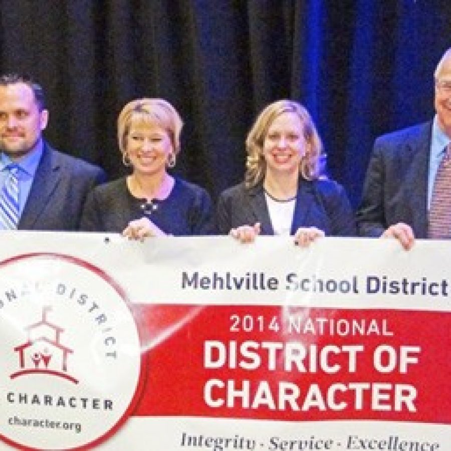 Representatives of the Mehlville School District accept the districts National District of Character award and banner earlier this month. From left: Witzel Alternative Academy Director John DeWalle, Assistant Superintendent-Supervision of Schools Lisa Counts, Blades Elementary administrative intern Laurie Tretter-Larkin and Superintendent Norm Ridder.