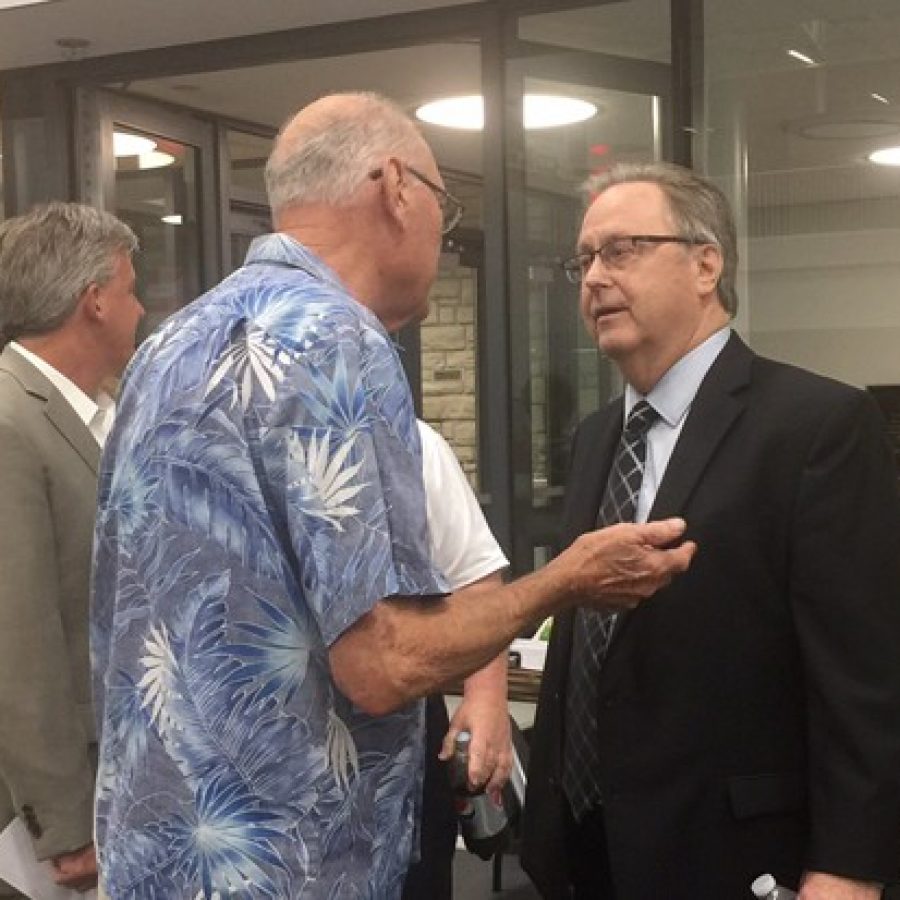 Sixth District County Councilman Kevin OLeary, D-Oakville, talks to a veteran Tuesday night after a public hearing on selling Sylvan Springs Park to expand Jefferson Barracks National Cemetery. Also pictured in the background is River City Casino General Manager Chris Plant, left.