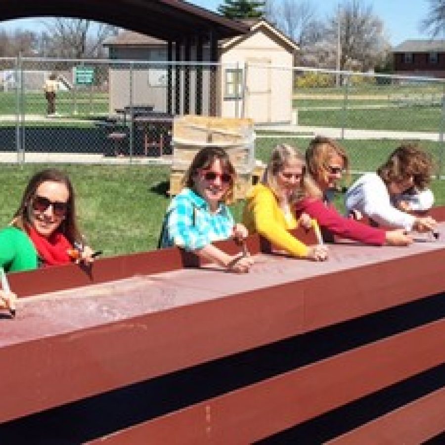 Lindbergh Early Childhood Education staff members Julianne Woodle, Teresa Darr, Barb Mikusch, Lori Beel and Teresa Steinacker sign a steel beam that will be used in the construction of Lindbergh Early Childhood Education West. 