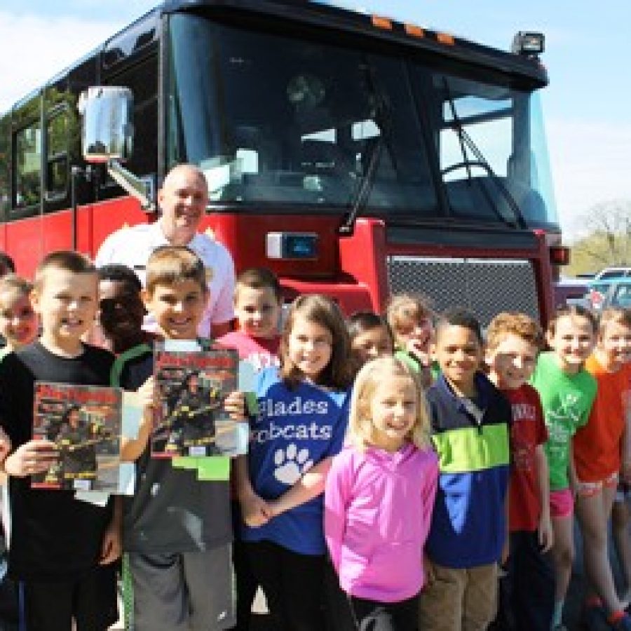 Mehlville Fire Protection District Capt. Kevin Reis is pictured with Blades Elementary School third-graders during his visit at the school.