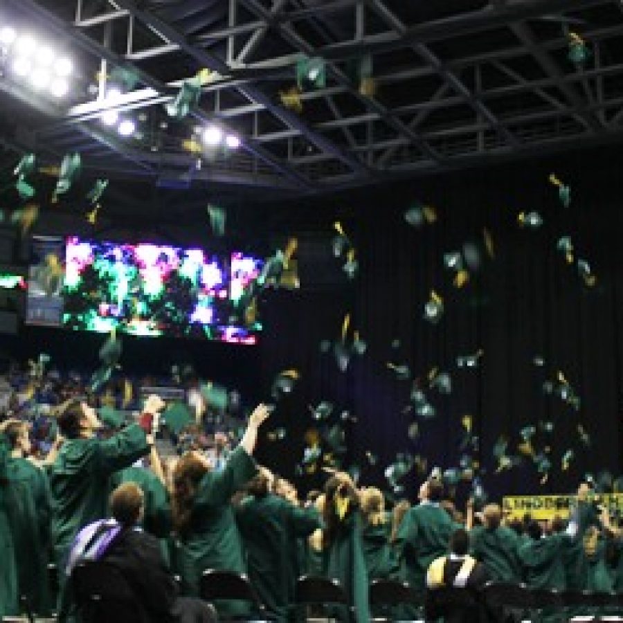 Members of the Lindbergh High School Class of 2015 toss their mortarboards in the air, in celebration of graduation Tuesday at Chaifetz Arena.