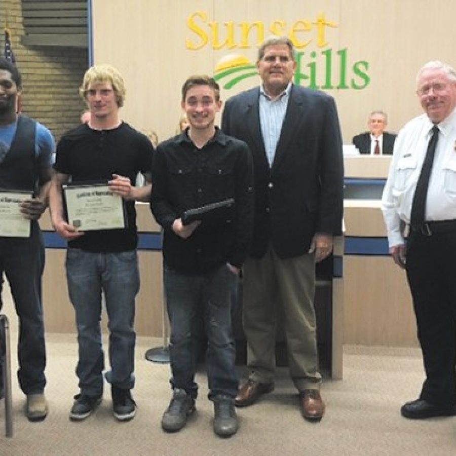 Mayor Mark Furrer and Police Chief William LaGrand present a proclamation to a heroic local moving crew. From left, movers Dareal Boykin, Brandon Lawler, Brandon Hausler, Furrer and LaGrand.