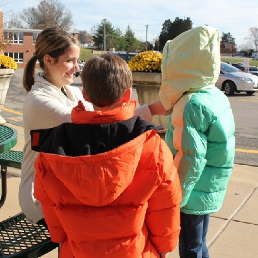 Sappington Elementary School Counselor Carolyn Hubert helps students try on new coats provided by the Crestwood-Sunset Hills Rotary Clubs Operation Warm program. The Rotary Club donated 104 coats, 60 hats and 60 pairs of gloves to Lindbergh students this year.