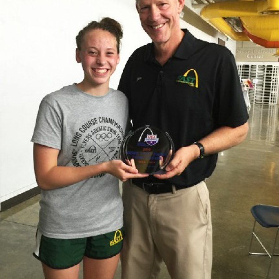 Bayley Helfrich of the Flyers Aquatic Swim Team and head coach Jim Halliburton are shown with Helfrichs second-place trophy that she won at the Ozark Long Course Championship meet in Carbondale, Ill.