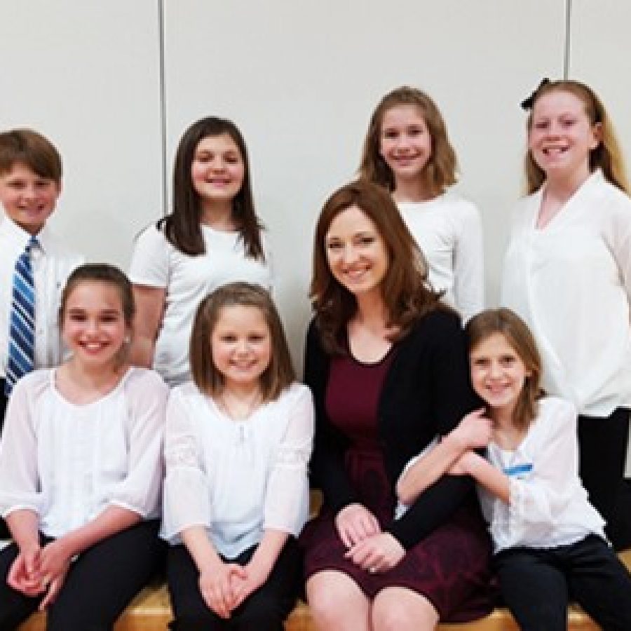 These Crestwood Elementary fifth-graders, shown with teacher Erin Caughlan, recently participated in the All-Suburban Fifth- and Sixth-Grade Honor Choir.