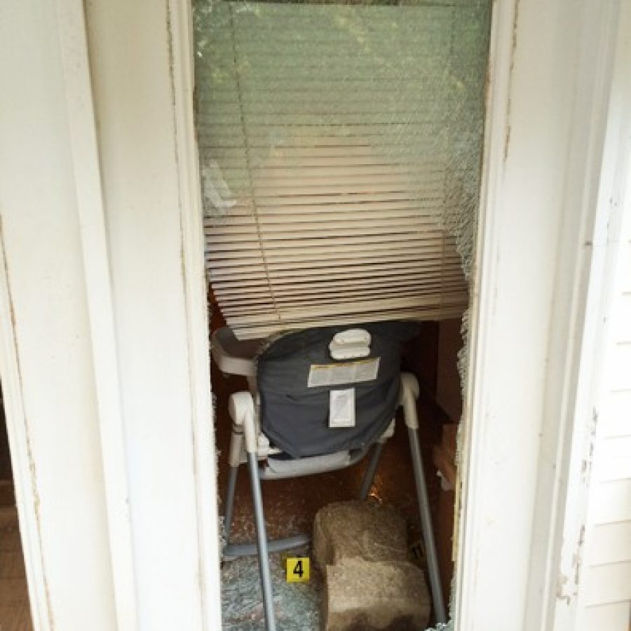 Police say an intruder fatally shot by an off-duty officer gained entry to a Lakeshire home by throwing this large, concrete planter through a rear door, shattering it.