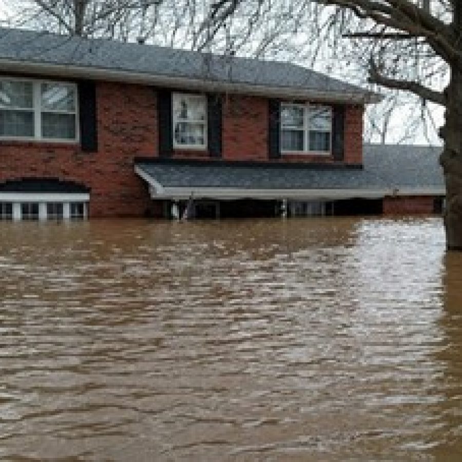 Pictured above, six feet of water cover the main floor and nearly reach the second story of Jennifer and Ryan Daniels house at 13344 West Watson after last months historic floods. 