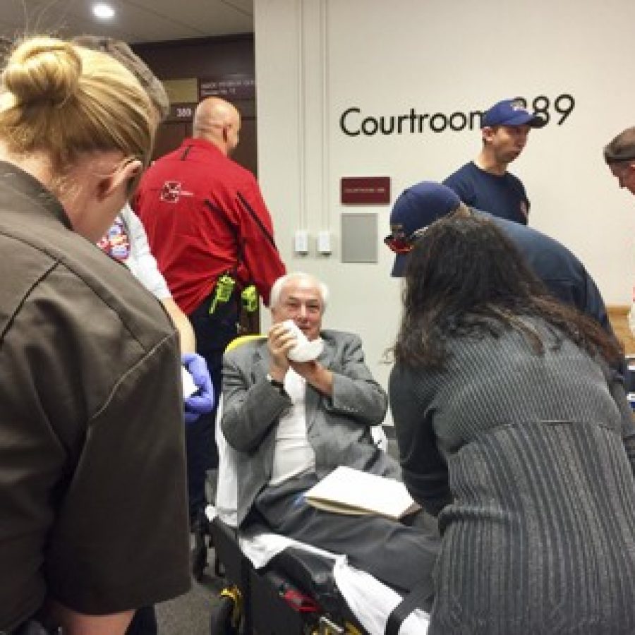 Post-Dispatch reporter Tim ONeil, sitting, is treated by Clayton paramedics after losing part of a finger Wednesday morning at the St. Louis County Courthouse. Photo by Gloria Lloyd