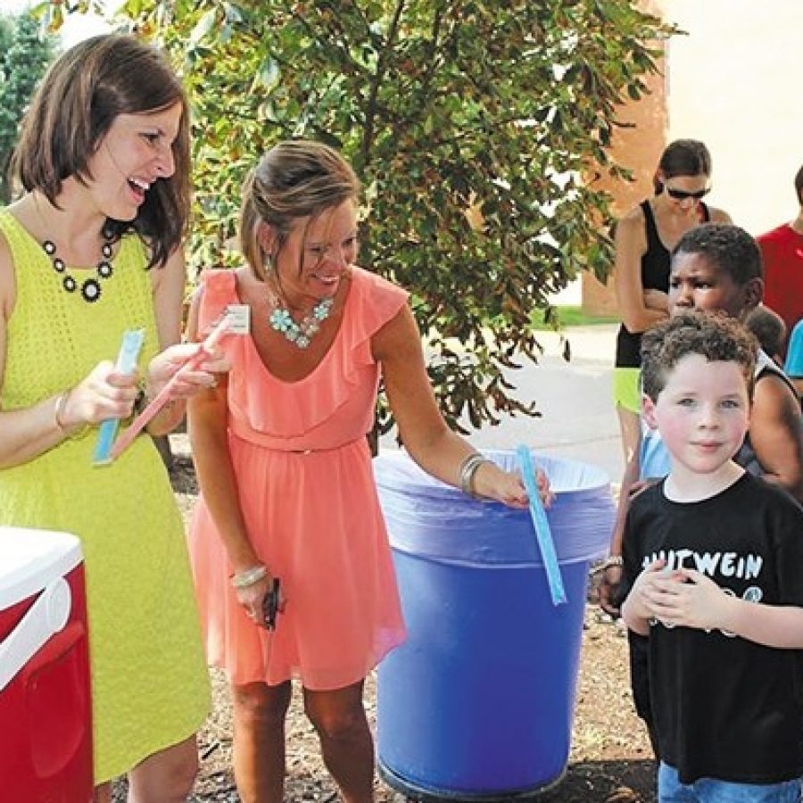 Trautwein and Point Assistant Principal Whitney Maus, left, is heading up redistricting with Bierbaum Assistant Principal Kelly Roberts. Above, Maus hands out Popsicles to Trautwein students at an event last summer with Principal Shannon Pike.
