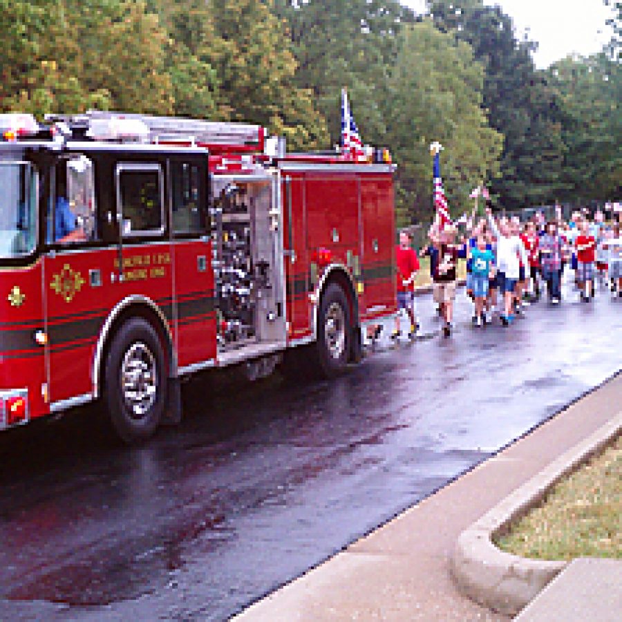 The students and staff at Rogers Elementary School are led on a Patriot Walk by Mehlville Fire Protection District firefighters on Sept. 9. The walk was part of the schools Sept. 11, 2001, commemoration activities.