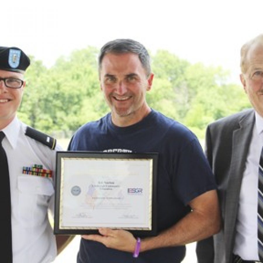 Bob Schure, right, awards coordinator for Missouri for the Employer Support of the Guard and Reserve, presents Lindbergh Schools Activities Director Kit Norton, center, with the Patriot Award. First Lt. Austin Okorn, left, nominated Norton for the award and thanked him for supporting his service to the United States.