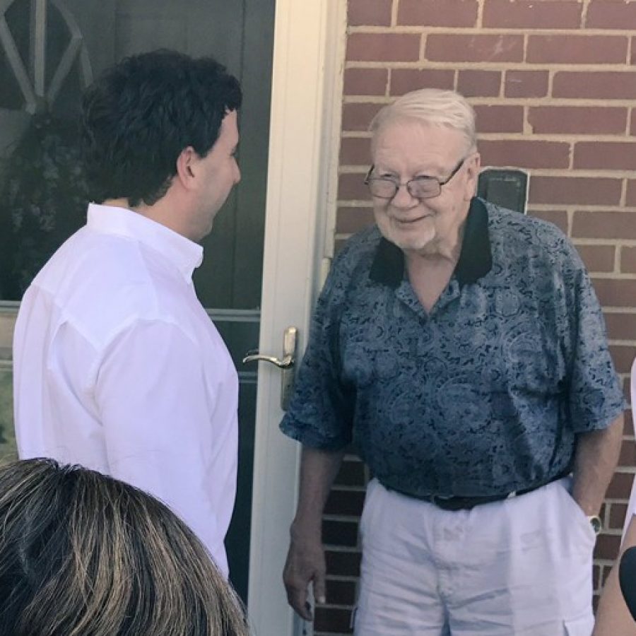 County Executive Steve Stenger, left, talks with an Affton man as Stenger went door-to-door with firefighters Thursday.