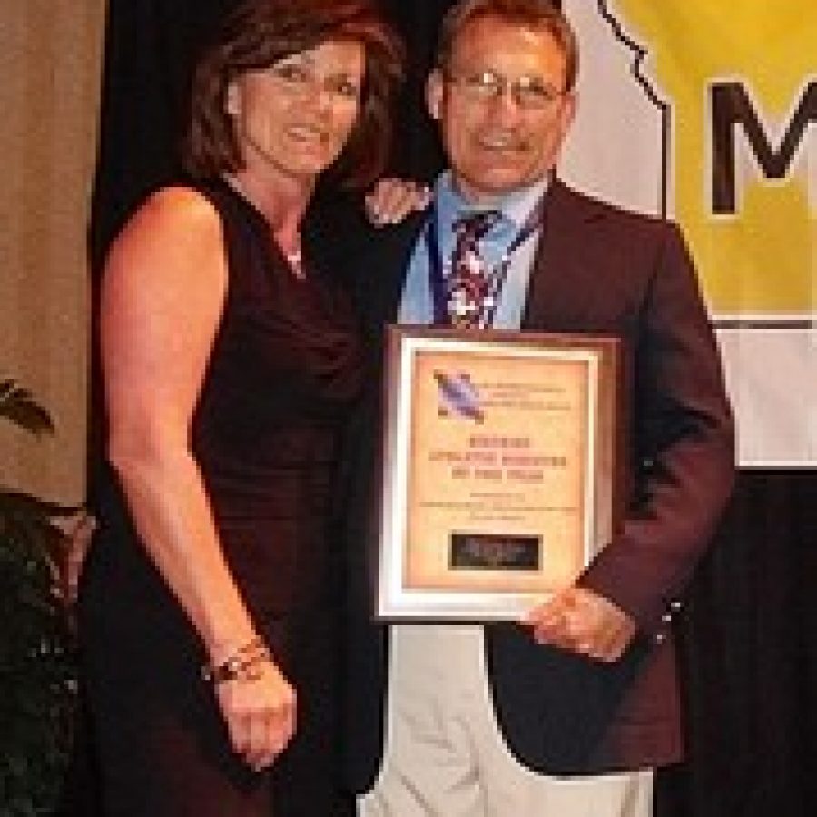 Lindbergh High School Athletics Director Mike Slyman, pictured with his wife, Sherry, accepts his award for St. Louis Area Athletic Director of the Year, during the MIAAA State Athletic Directors Conference.
 