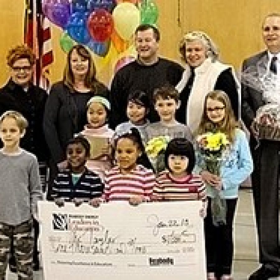 Crestwood Principal Scott Taylor is shown with his Peabody Award check. Pictured, back row, from left, are: Lori Ehrig, Becky Taylor, Taylor, Maureen Moore and Superintendent Jim Simpson. Middle row, from left, are: Amelia Luong, Hikari Ubukata, Cooper Sweeney and  Abigail Helmer. Front row, from left, are: Drew Lanio, Navin Narayanan, Kayla Williams and Christina Ha. 